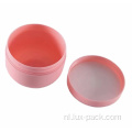 Lege cosmetische roze plastic gevormde crèmekleurige gezichtskom